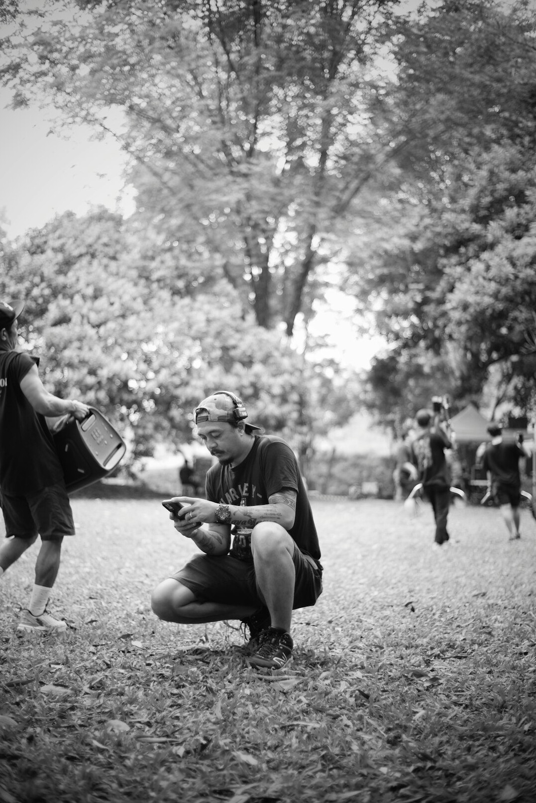 Group of adult students learning photography outdoors
