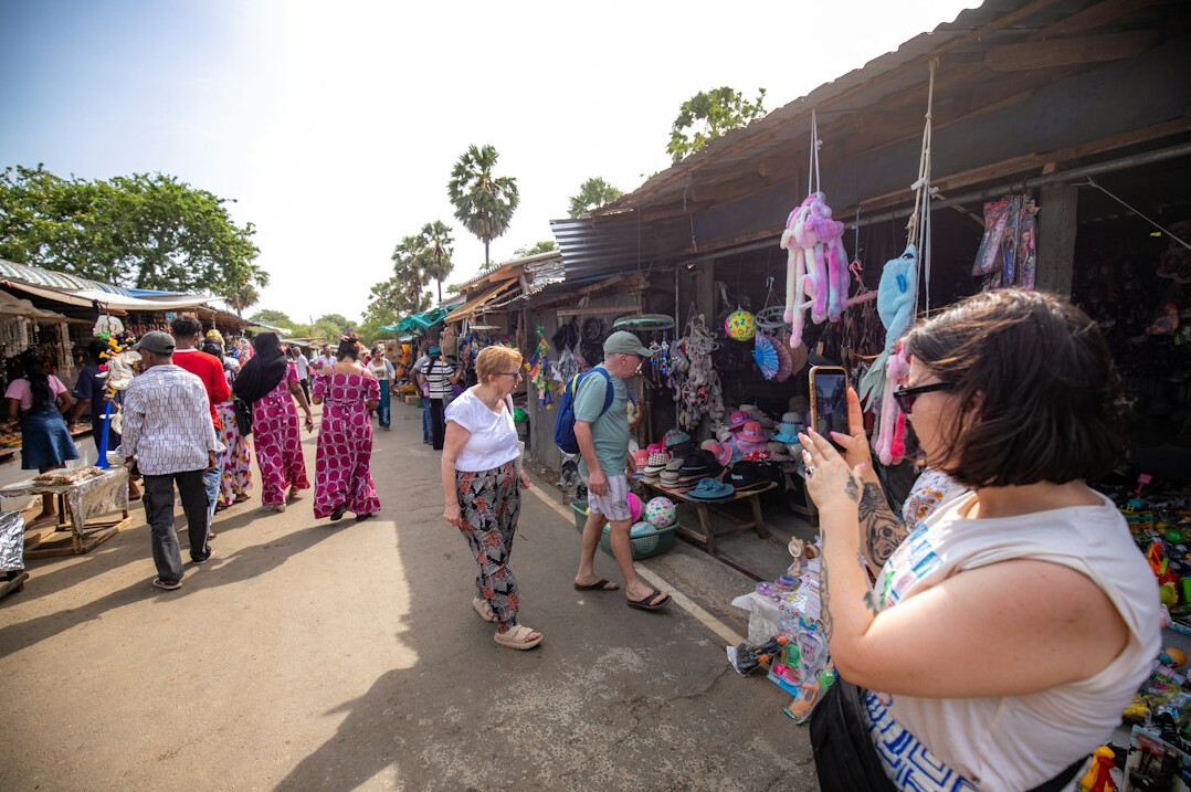 Photographer capturing a candid photo at a local market